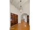 Spacious foyer featuring Saltillo tile flooring, wooden doors, arched doorways, and unique lighting fixture at 13007 N 1St St, Phoenix, AZ 85022