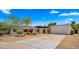 Charming single-story home with desert landscaping, a covered front patio, and an attached two-car garage at 13007 N 1St St, Phoenix, AZ 85022