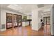 Open kitchen with terracotta tile flooring, double glass doors, white cabinetry, and stainless steel appliances at 13007 N 1St St, Phoenix, AZ 85022