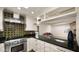 Granite countertops and stainless steel appliances accent this modern kitchen with adjacent living space at 13007 N 1St St, Phoenix, AZ 85022