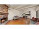 A spacious living room with terracotta tile floors, brick fireplace, and access to the kitchen at 13007 N 1St St, Phoenix, AZ 85022