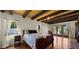 Relaxing bedroom with beamed ceiling, wood floors, and bright natural light at 13007 N 1St St, Phoenix, AZ 85022