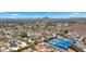 Expansive neighborhood view showcasing residences, tennis courts, swimming pools, and lush landscaping nestled near mountains at 13007 N 1St St, Phoenix, AZ 85022