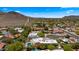 Overhead view of homes with private pools and lush landscaping, situated in a vibrant community near scenic mountains at 13007 N 1St St, Phoenix, AZ 85022