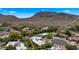 Aerial view of a residential neighborhood with mountain views, lush landscaping, and community amenities like tennis courts at 13007 N 1St St, Phoenix, AZ 85022