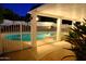 An inviting backyard oasis featuring a sparkling pool with a covered patio, perfect for outdoor relaxation and entertaining at 13007 N 1St St, Phoenix, AZ 85022