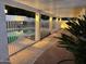 An inviting backyard oasis featuring a sparkling pool with a covered patio and ambient lighting, perfect for entertaining at 13007 N 1St St, Phoenix, AZ 85022