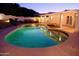 Beautifully lit pool at dusk, perfect for peaceful evening swims and creating a serene backyard ambiance at 13007 N 1St St, Phoenix, AZ 85022