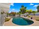 Backyard featuring a refreshing pool and serene ambiance, perfect for luxurious outdoor living and entertaining at 13007 N 1St St, Phoenix, AZ 85022