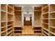 Spacious walk-in closet with custom shelving and mirrored doors to bathroom at 13007 N 1St St, Phoenix, AZ 85022