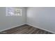 Bedroom featuring wood-look flooring and a window at 1325 W 7Th Ave, Mesa, AZ 85202
