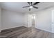 Bedroom featuring wood-look flooring, fan, and views into hallway at 1325 W 7Th Ave, Mesa, AZ 85202