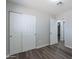 Bedroom featuring wood-look flooring, closet, and views into hallway at 1325 W 7Th Ave, Mesa, AZ 85202