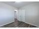 Bedroom featuring wood-look flooring, closet, and views into hallway at 1325 W 7Th Ave, Mesa, AZ 85202