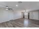Open living room with wood-look flooring, ceiling fans, and ample natural light at 1325 W 7Th Ave, Mesa, AZ 85202