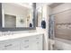 Bright bathroom featuring marble counters, dual sinks, and a shower/tub combo at 13561 W Montebello Ave, Litchfield Park, AZ 85340