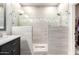 Modern bathroom with a dual-head walk-in shower, elegant tile work, and a dark vanity at 13561 W Montebello Ave, Litchfield Park, AZ 85340