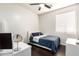 Cozy bedroom with ceiling fan and large window providing ample natural light at 13561 W Montebello Ave, Litchfield Park, AZ 85340