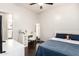 Nicely decorated bedroom featuring wood flooring and an adjacent bathroom at 13561 W Montebello Ave, Litchfield Park, AZ 85340