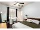 Comfortable bedroom with a ceiling fan, desk, large mirror and a window with blackout curtains at 13561 W Montebello Ave, Litchfield Park, AZ 85340