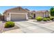 Beautiful single-Gathering home showcasing a spacious driveway, three-car garage, and desert landscaping at 13561 W Montebello Ave, Litchfield Park, AZ 85340