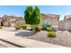 Attractive single-Gathering home features well-maintained desert landscaping and a mature shade tree at 13561 W Montebello Ave, Litchfield Park, AZ 85340