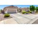 Beautiful single-Gathering home showcasing a spacious driveway, three-car garage, and desert landscaping at 13561 W Montebello Ave, Litchfield Park, AZ 85340