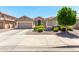 Charming single-story home with a well-manicured front yard, mature trees, and a spacious three-car garage at 13561 W Montebello Ave, Litchfield Park, AZ 85340