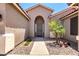 Inviting front entrance with rock landscaping and desert flora, creating a warm curb appeal at 13561 W Montebello Ave, Litchfield Park, AZ 85340