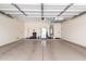 Spacious two car garage featuring epoxy floor coating, painted walls, and plenty of room for storage at 13561 W Montebello Ave, Litchfield Park, AZ 85340