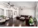Spacious living room with dark wood floors, ceiling fans, and neutral-toned furniture at 13561 W Montebello Ave, Litchfield Park, AZ 85340