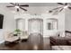 Bright living room with hardwood floors, neutral walls, arched doorways, and comfortable seating at 13561 W Montebello Ave, Litchfield Park, AZ 85340