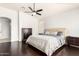 Spacious main bedroom with wood floors, ceiling fan, neutral colors, and a comfortable bed at 13561 W Montebello Ave, Litchfield Park, AZ 85340
