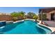 Gorgeous backyard pool with a tanning ledge, a rock waterfall feature and lush landscaping at 13561 W Montebello Ave, Litchfield Park, AZ 85340