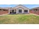 Home exterior and backyard with covered patio and grass at 146 E Rock Wren Dr, San Tan Valley, AZ 85143