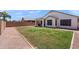 Spacious backyard with a brick-lined gravel border and grass at 146 E Rock Wren Dr, San Tan Valley, AZ 85143