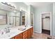 Spacious bathroom with double sinks, tiled floors, walk-in shower, and separate toilet room at 146 E Rock Wren Dr, San Tan Valley, AZ 85143