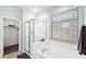 Bathroom featuring a large tub, shower, and a window that lets in natural light at 146 E Rock Wren Dr, San Tan Valley, AZ 85143