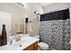 Bright bathroom with a single sink vanity, decorative bull skull, and patterned shower curtain at 146 E Rock Wren Dr, San Tan Valley, AZ 85143