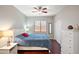 Bedroom with wood floors, ceiling fan, closet, and large window for natural light at 146 E Rock Wren Dr, San Tan Valley, AZ 85143