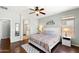 Light and airy bedroom featuring a ceiling fan, wood floors, and ensuite bath entrance at 146 E Rock Wren Dr, San Tan Valley, AZ 85143