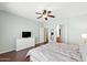 A well-lit bedroom with hardwood floors, a ceiling fan, and a bright dresser at 146 E Rock Wren Dr, San Tan Valley, AZ 85143