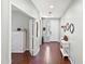 Inviting entryway with hardwood floors, white wainscoting and trim and view of a bedroom at 146 E Rock Wren Dr, San Tan Valley, AZ 85143