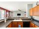 Well-appointed kitchen with dark countertops, stainless steel sink, and wood cabinets at 146 E Rock Wren Dr, San Tan Valley, AZ 85143