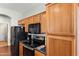 Functional kitchen with black appliances, dark countertops, and wood cabinets at 146 E Rock Wren Dr, San Tan Valley, AZ 85143