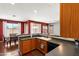 Spacious kitchen with counter seating, dark countertops, and view to dining area at 146 E Rock Wren Dr, San Tan Valley, AZ 85143