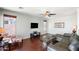 Comfortable living room with wood floors, ceiling fan, TV and large windows at 146 E Rock Wren Dr, San Tan Valley, AZ 85143
