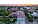 Stunning twilight aerial view of the home showcasing a spacious lot with mature trees and a well-manicured front yard at 1532 N Ogden --, Mesa, AZ 85205