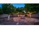 Enchanting backyard showcasing a lovely water fountain, mature citrus trees with string lights, and a stone pathway at 1532 N Ogden --, Mesa, AZ 85205