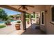 Covered backyard patio with ceiling fans, plants and a view of the pool at 1532 N Ogden --, Mesa, AZ 85205